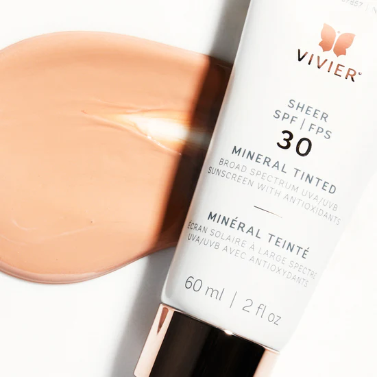 Vivier SHEER SPF 30 Mineral Tinted tube beside a tinted sunscreen swatch