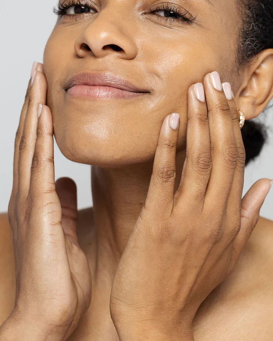 Portrait of a woman touching both cheeks