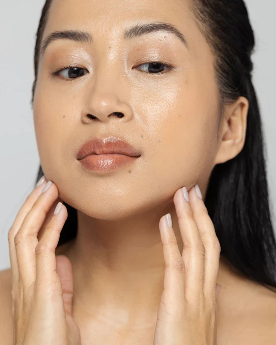 Portrait of a woman touching her jawline