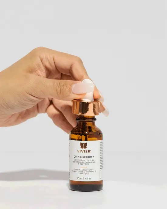 Hand opening a Vivier QuintiSerum dropper bottle